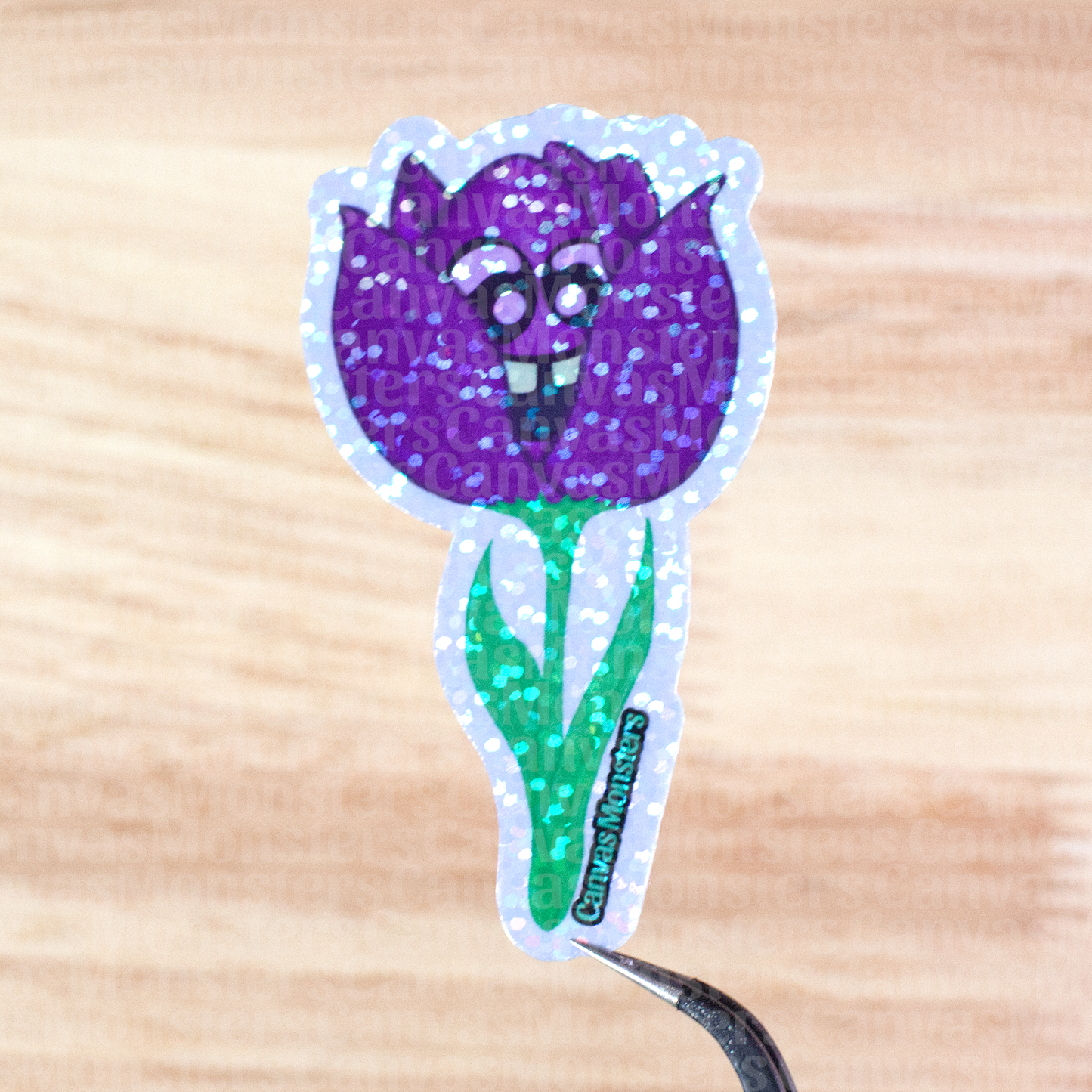 Glittery purple flower sticker on a wooden surface