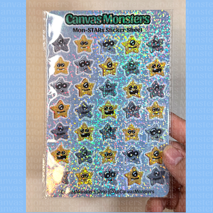 Sheet of star-shaped stickers with faces on a blue background branded 'Canvas Monsters', held by a hand against a beige background.