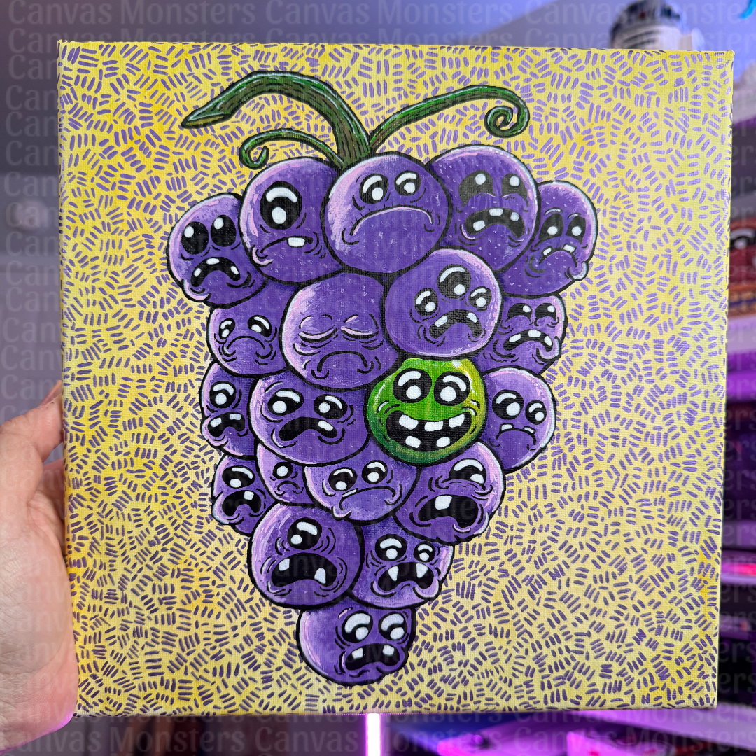 A square canvas painting featuring a cluster of purple grapes with sad cartoon faces, with one green grape smiling, held by a hand against a colorful background.