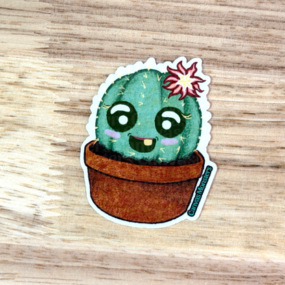 Cartoon cactus sticker with a flower on a wooden surface