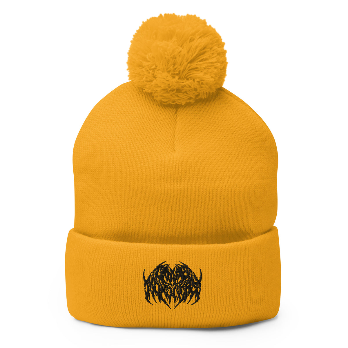 Image of a knit beanie with a pom pom on top, in golden yellow with a metal text logo on the front.