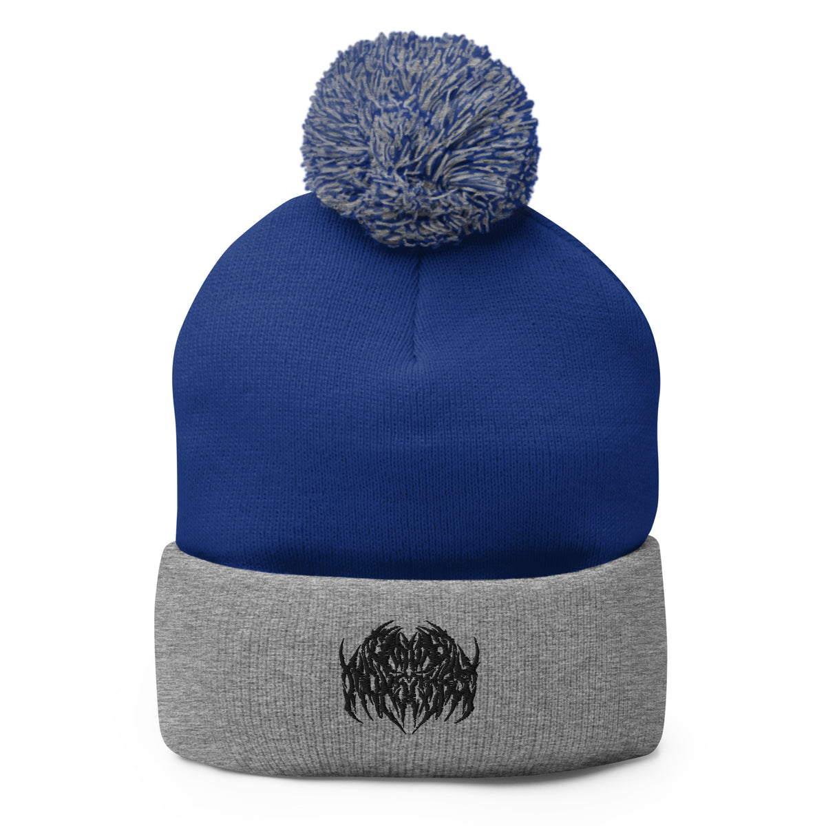 Image of a knit beanie with a pom pom on top, in blue and heather gray with a metal text logo on the front.