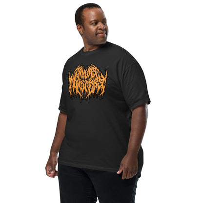 A man wearing a black short-sleeve t-shirt with a large orange and black stylized graphic on the chest, posed against a solid white background.