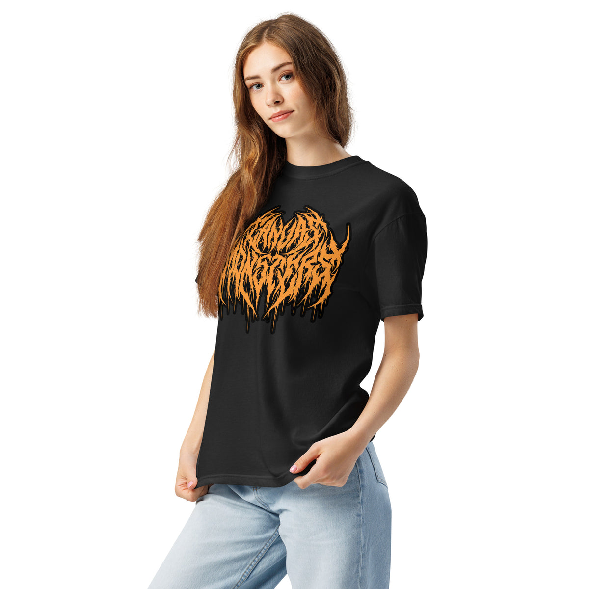 A woman modeling a black short-sleeve t-shirt with a large orange dripping metal graphic on the front, paired with light blue jeans, against a plain white background.