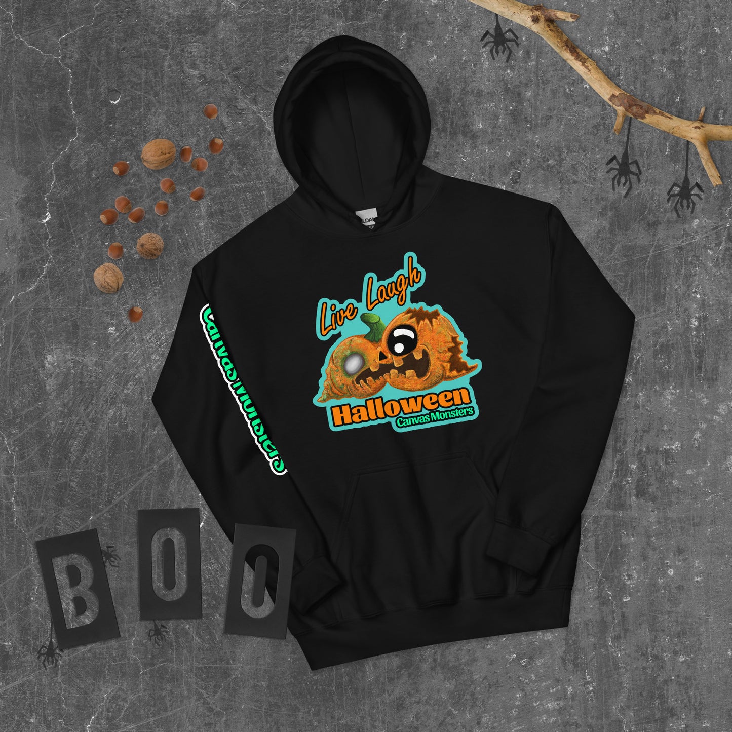 Black hoodie with Halloween-themed design on a textured gray background