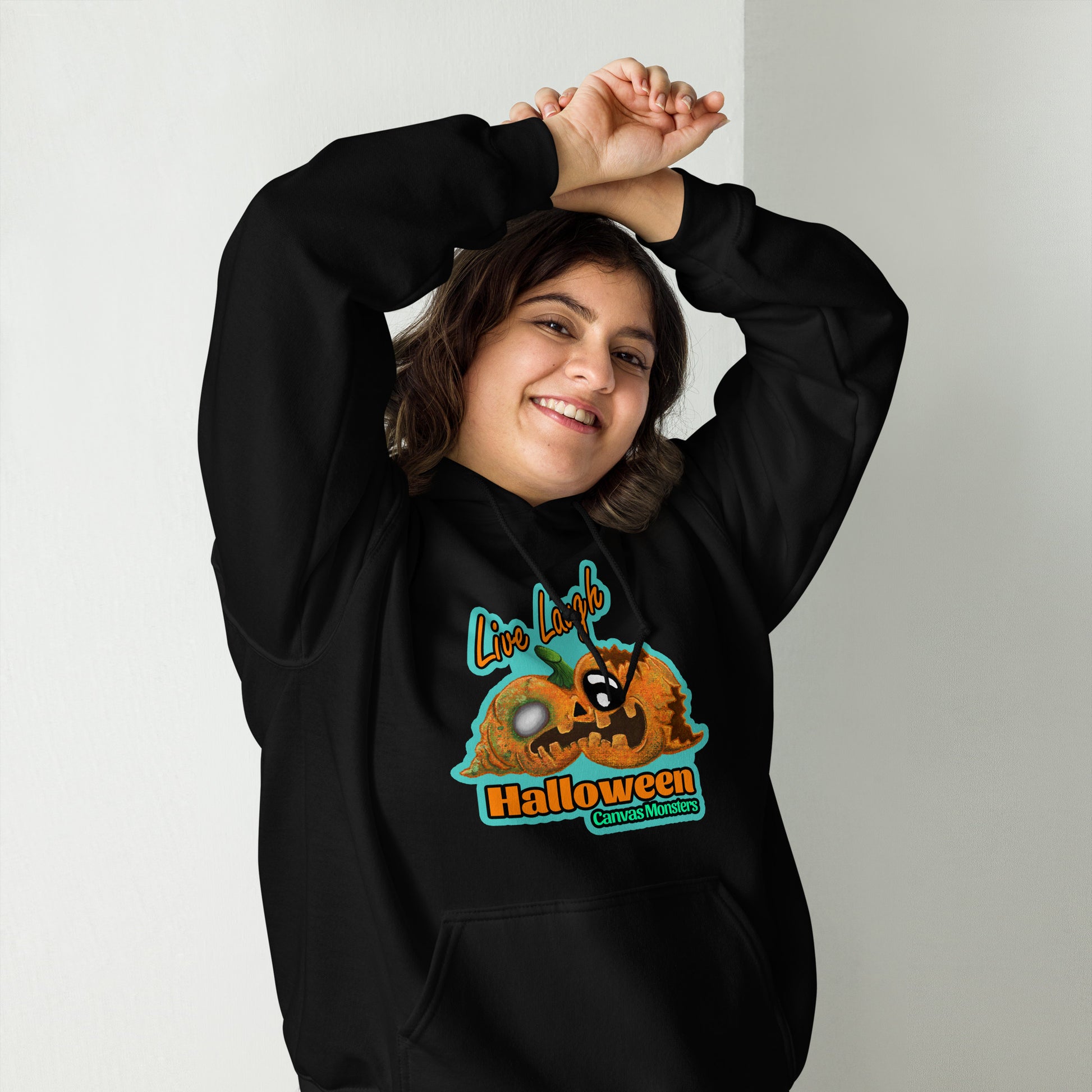 Person wearing a black hoodie with a Halloween design on a plain background