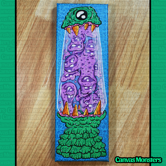 Painting of a lava lamp creature, filled with a purple goop creature. Painting is sitting on a wooden surface, brand 'Canvas Monsters' visible.