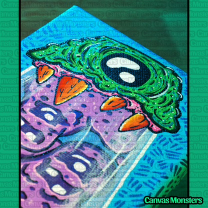 Close up of the top half of the lava lamp painting. Showing a metallic green top with a single eye, painted in black and white. Also shown are orange, spiky teeth.